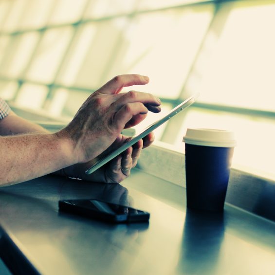 close up man’s hands with tablet