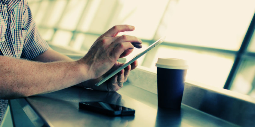 close up man’s hands with tablet